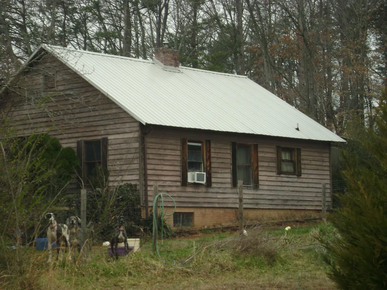 White metal roof on an old wood sided farmhouse, from a Metal Roof Installation job in Blacklick